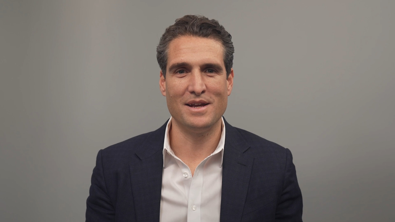 Abstract image featuring layered green wavy shapes, creating a sense of depth and motion on a smooth gradient background.