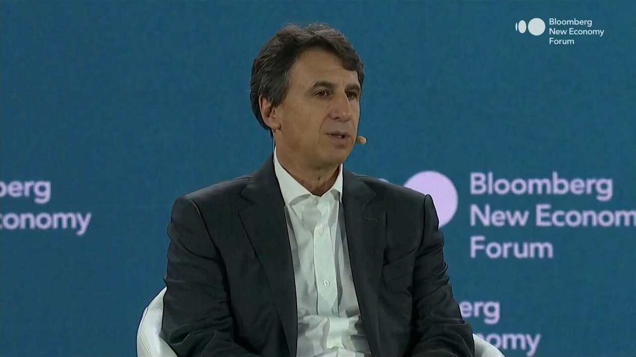 Marc Rowan, Apollo CEO, is seated on stage in a dark suit and white shirt, speaking into a headset mic at the 2025 Bloomberg New Economy Forum in Singapore, with a teal background displaying the event’s logo.