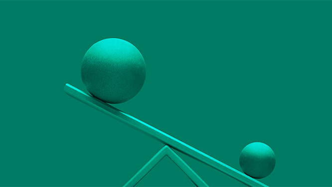 Two teal spheres of unequal size resting on a wooden seesaw against a green background