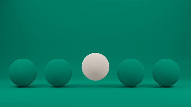 Single white sphere standing out from a row of green spheres.