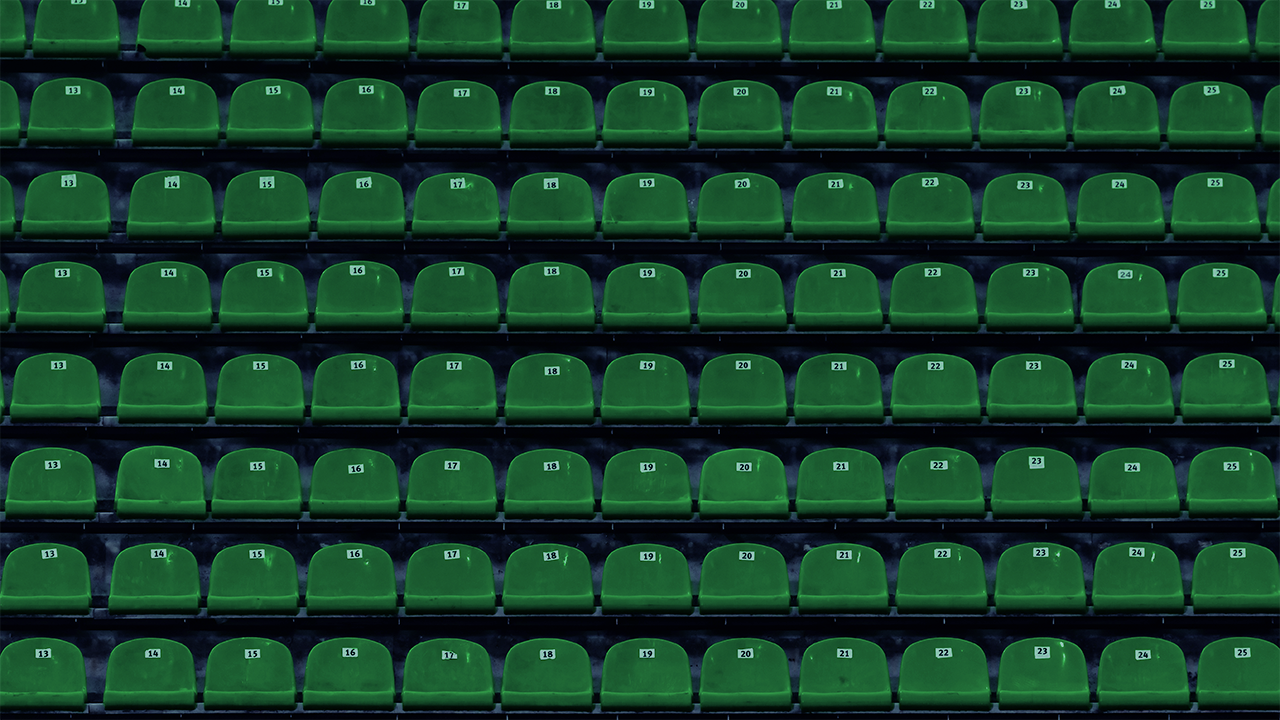 Rows of empty green stadium seats with white numbered labels, arranged in precise symmetry, representing Apollo Sports Capital