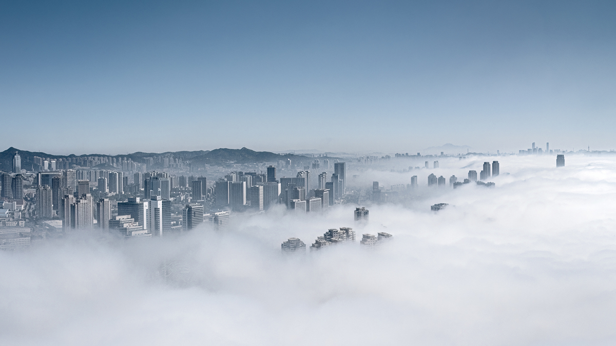 Fog-covered city skyline representing the scale of private credit and its role in supporting the real economy